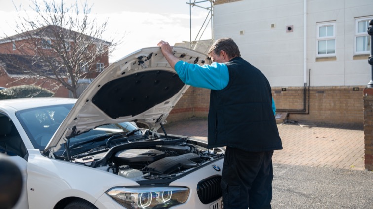 Car Buyer Inspecting Car Engine